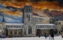 Visitors linger on the snow covered green as light fades.