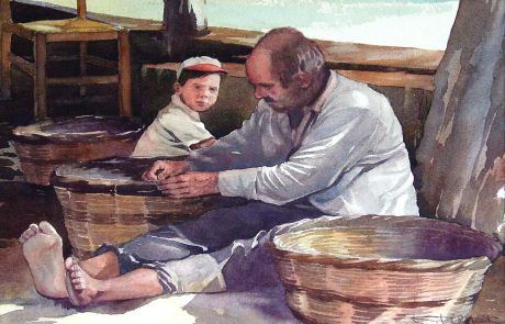 A fisherman mending baskets watched by his young protegè 
on the island of Skiathos in Greece.